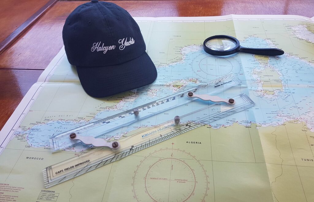 Superyacht Crew Agency. Hat and parallel rule on a nautical chart. 